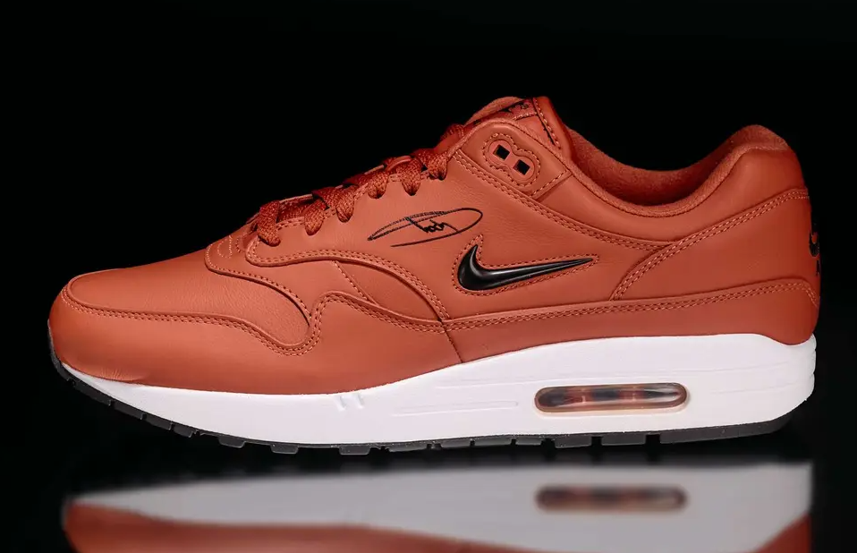 A close-up view of a red Nike Air Max 1 sneaker with a white midsole and black accents.