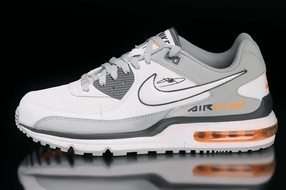 A pair of white and gray Nike Air Max sneakers with orange accents and the Nike logo visible.