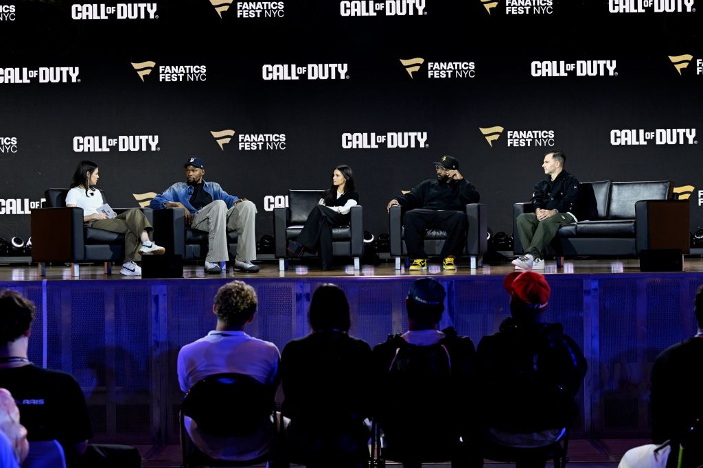 A panel discussion at the Call of Duty: Modern Warfare 4 event at Fanatics Fest NYC 2026, featuring speakers on stage in front of an audience.