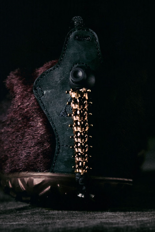 A black leather holster with a metallic clasp and a textured leather strap.
