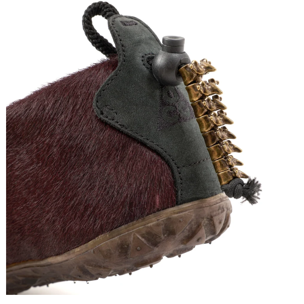 Pair of rugged, burgundy-colored boots with metal studs and a thick, black sole.