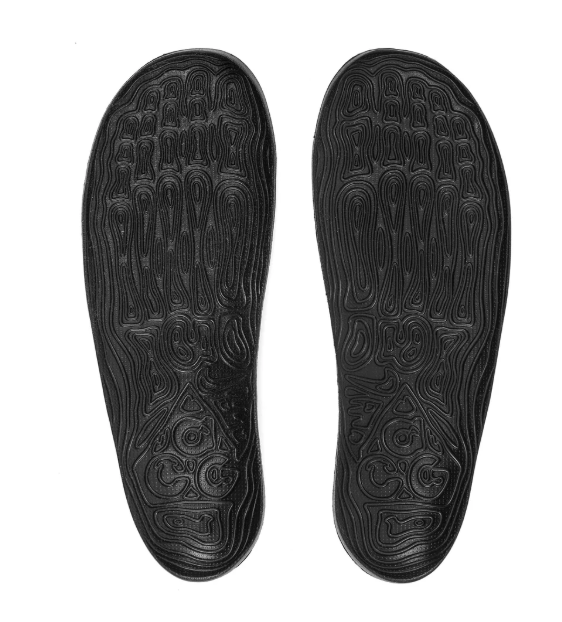 Two black shoe soles with intricate, swirling patterns.