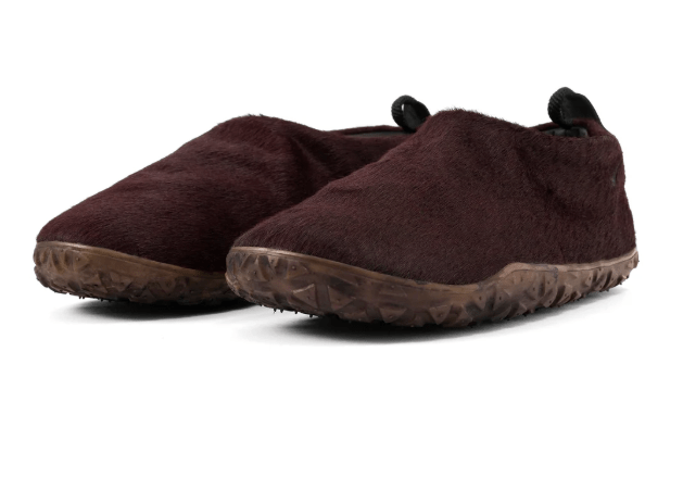 A pair of brown fuzzy slippers or house shoes.
