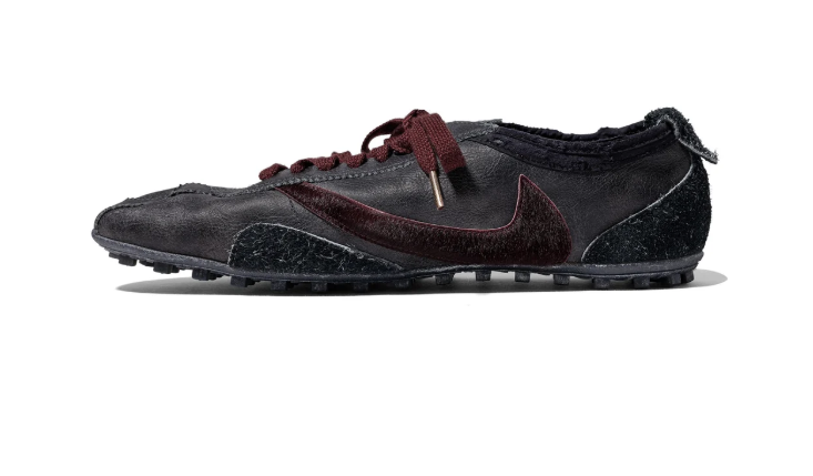 A black and burgundy sneaker with a textured upper and lace-up closure.