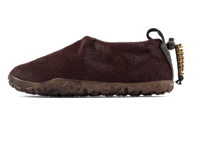 A burgundy-colored Nike shoe with a textured upper and a rugged sole.