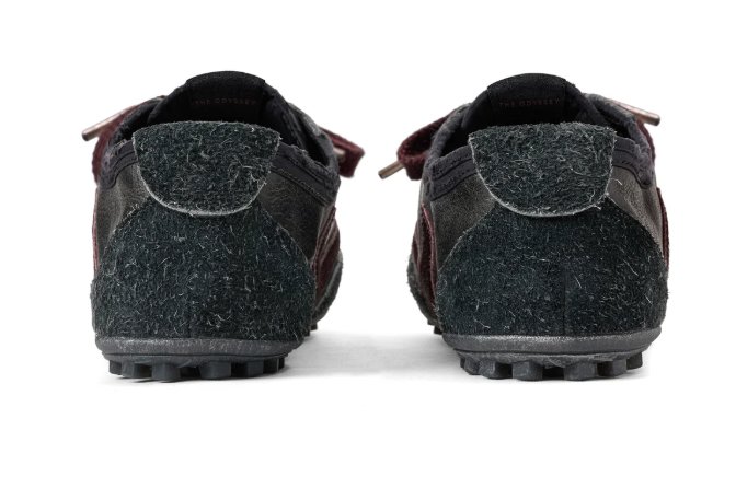 A pair of black and burgundy leather shoes with a textured pattern.