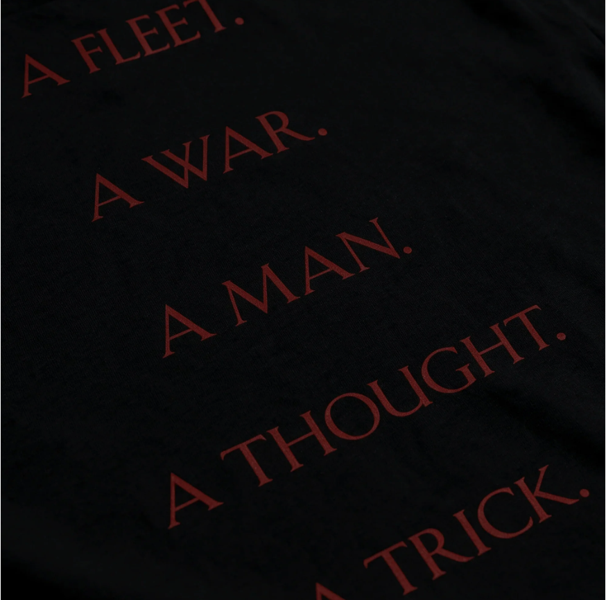 A dark background with the text "A FLEET. A WAR. A MAN. A THOUGHT.