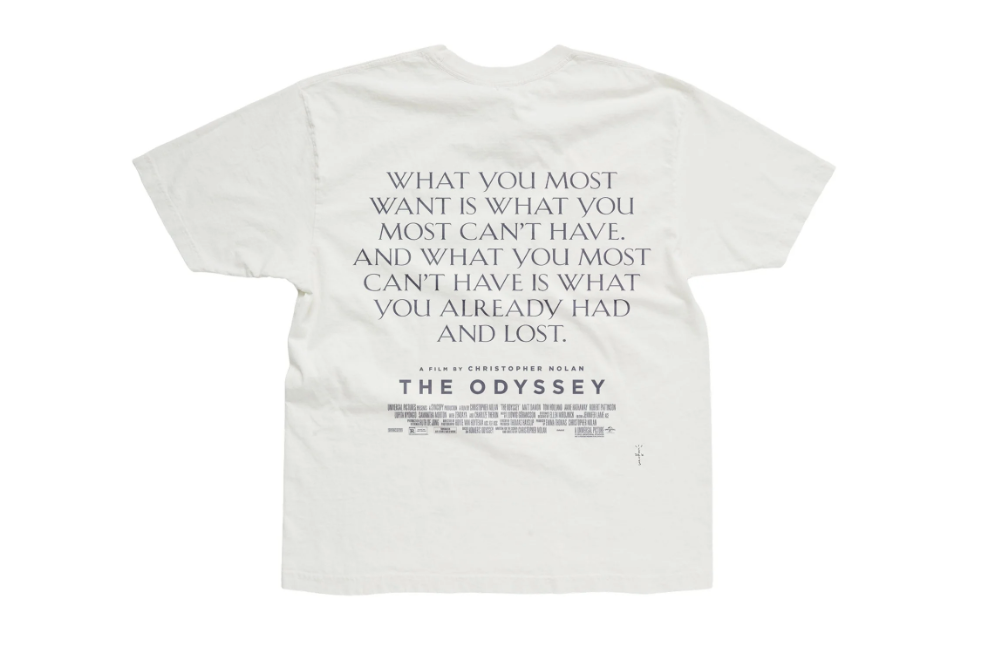 A white t-shirt with the text "WHAT YOU MOST WANT IS WHAT YOU MOST CAN'T HAVE. AND WHAT YOU MOST CAN'T HAVE IS WHAT YOU ALREADY HAD AND LOST." and the movie title "THE ODYSSEY" below.
