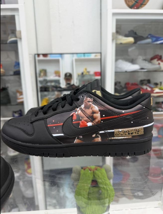 A pair of black sneakers with a graphic design featuring a wrestler and the text "Supreme Martin".