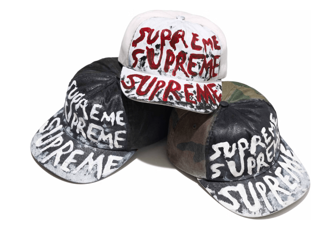 Several hats with the text "Supreme" printed on them in various styles and colors.