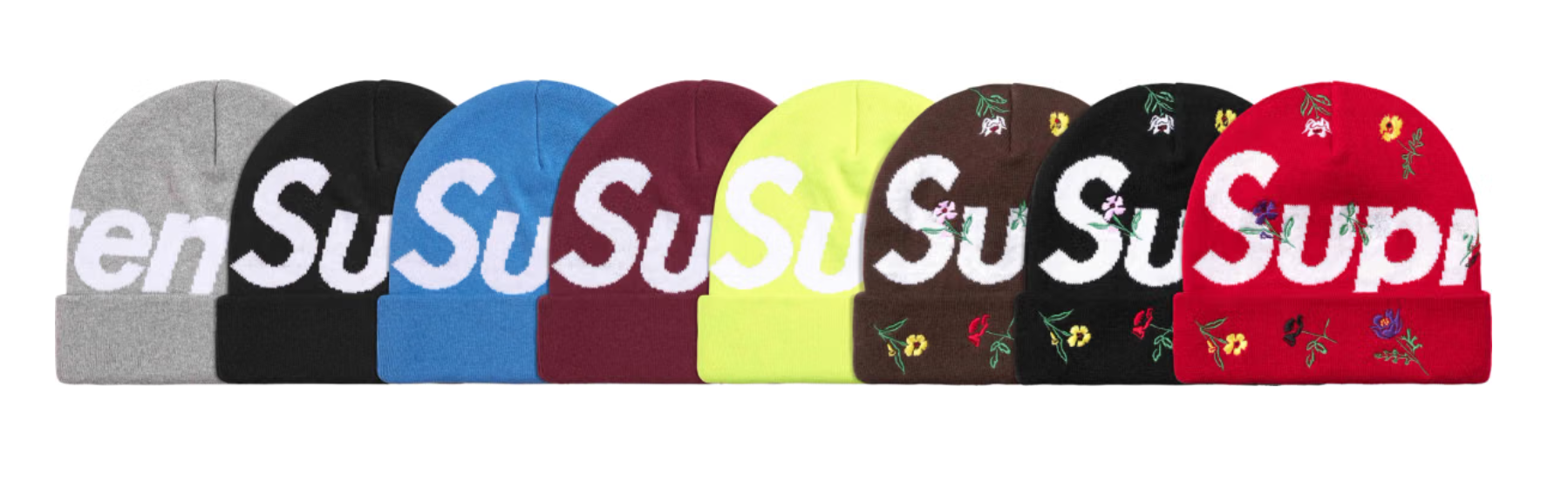 Assorted beanies in various colors and patterns, including the word "Supreme" printed on them.