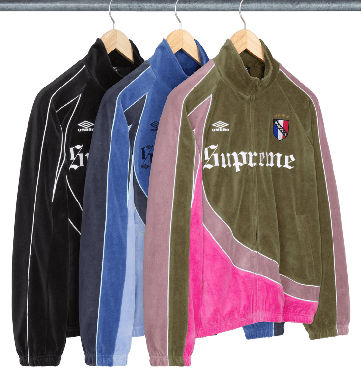 Assorted Supreme-branded hoodies and jackets in various colors hanging on a clothing rack.