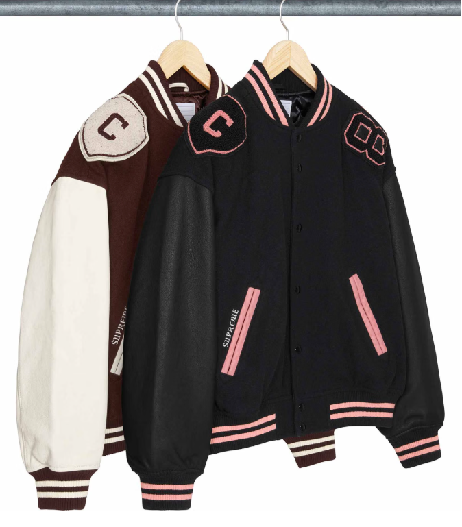Three black and burgundy varsity jackets with pink and white stripes and logos on a clothing rack.