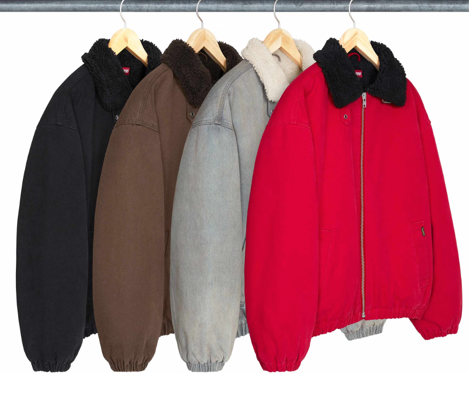 Assorted winter coats in black, brown, gray, and red hanging on a clothing rack.