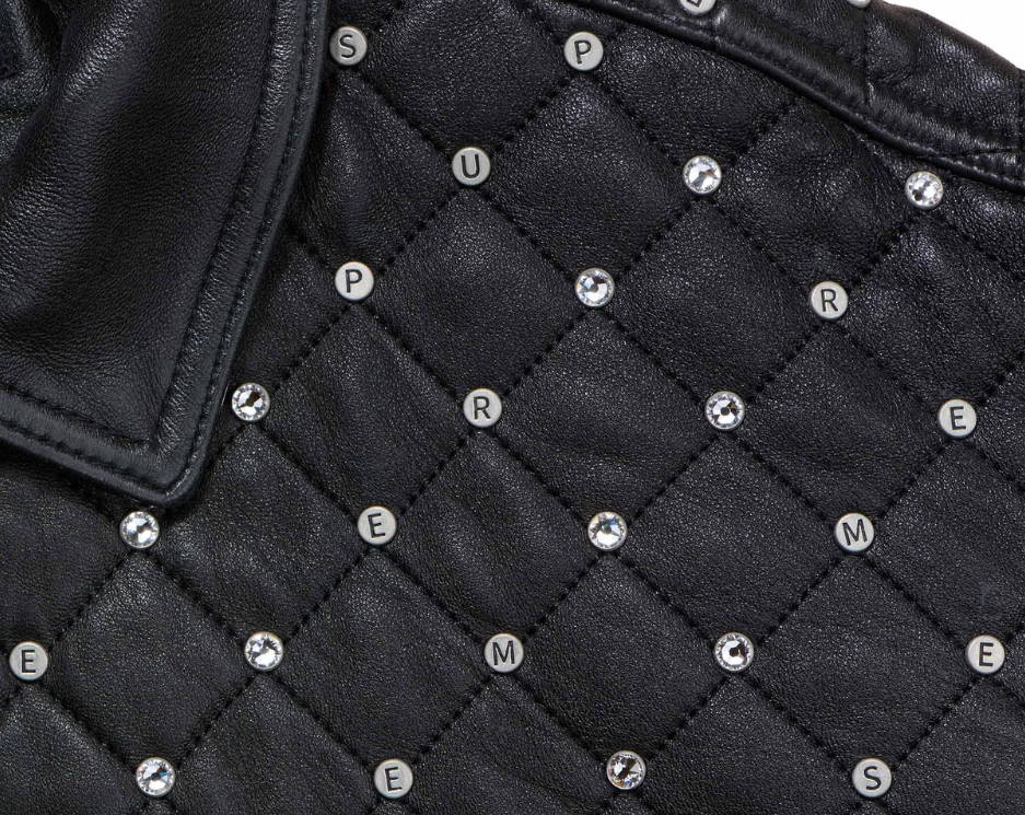 Black leather jacket with diamond-shaped quilted pattern and metal studs.