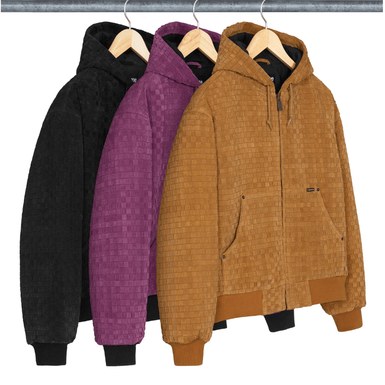 Three hooded jackets in black, purple, and tan colors hanging on a metal clothing rack.