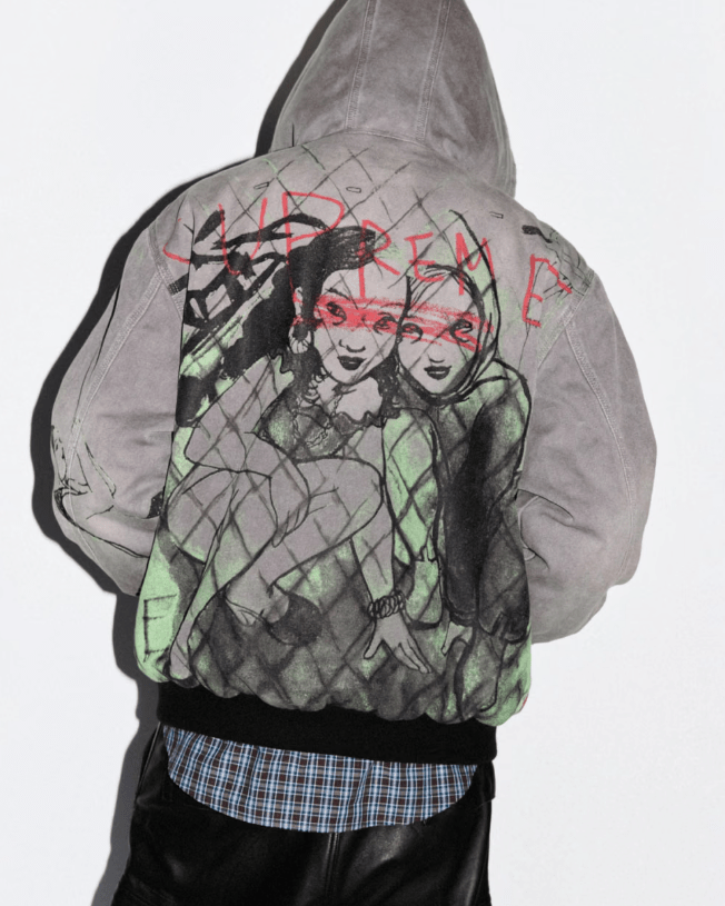 A hooded figure wearing a gray sweatshirt with a graphic design depicting two stylized faces.