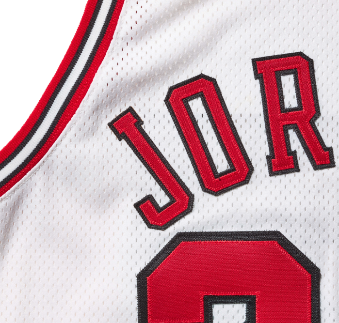 A white basketball jersey with the text "JOR" in large red letters.