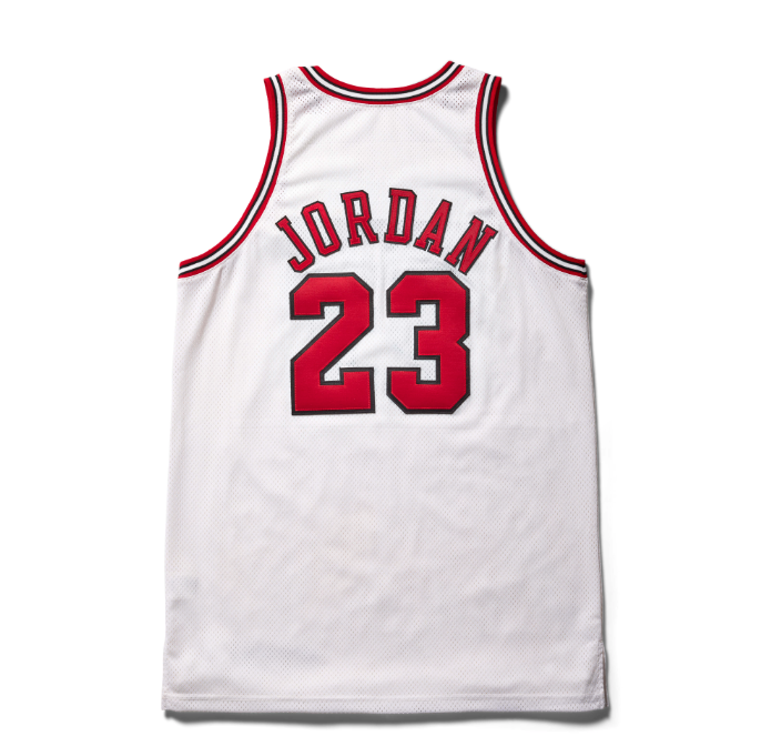 A white basketball jersey with the number 23 and the name "JORDAN" printed in red.