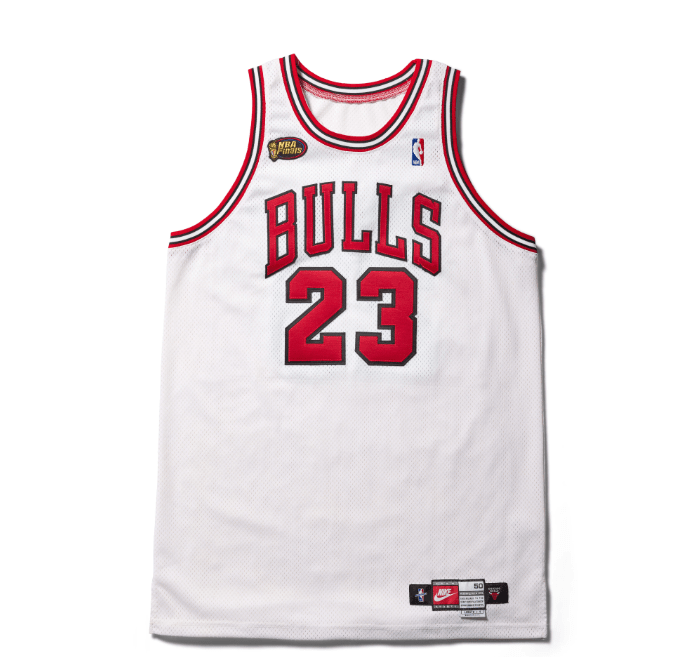 White basketball jersey with "BULLS 23" printed in red and black text.