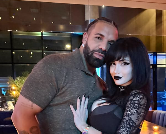 A man with a beard embracing a woman with dark hair in a dimly lit setting.