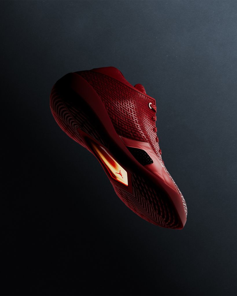 A close-up view of a red and black athletic shoe with a distinctive pattern and branding.