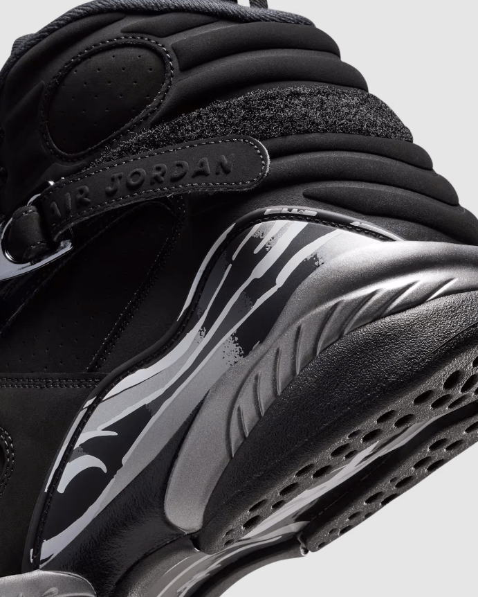 Close-up of a black and white Nike Air Jordan sneaker with distinctive Air Jordan branding and textured sole.