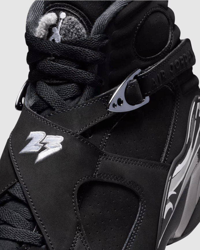 Close-up of a black and gray Nike Air Jordan 23 sneaker with laces and a strap.