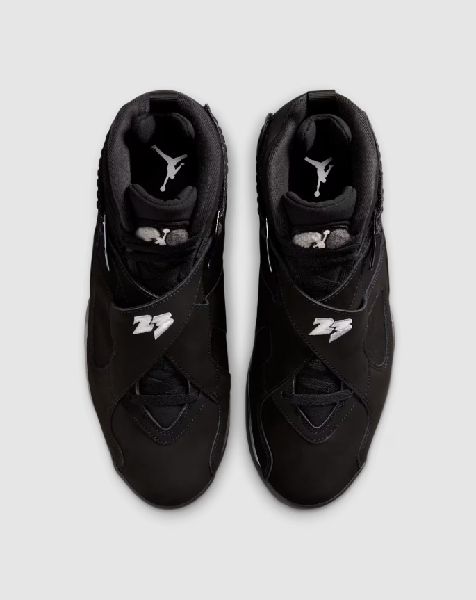 A pair of black Nike Air Jordan 7 sneakers with the "23" logo visible.