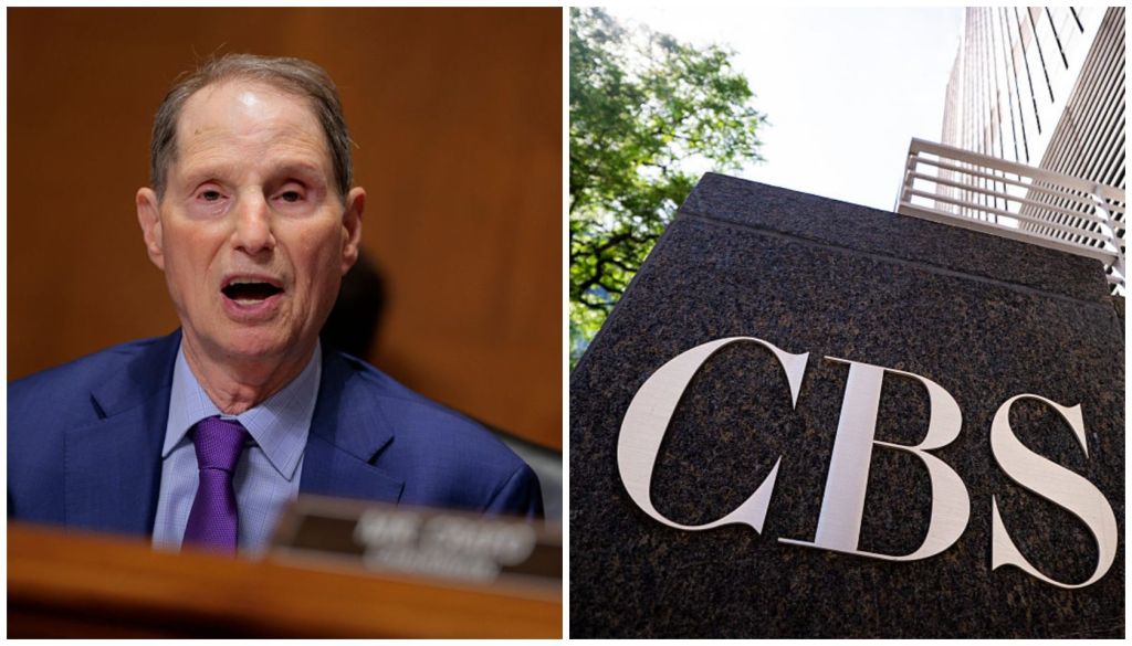 A man in a suit and tie gesturing emphatically while speaking at a podium, with the CBS logo visible on a building in the background.